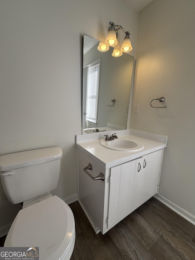 bathroom featuring vanity, hardwood / wood-style flooring, and toilet