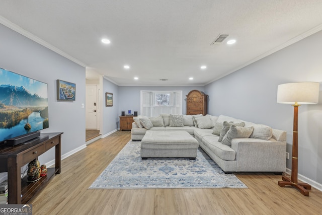 living room with crown molding and light hardwood / wood-style floors