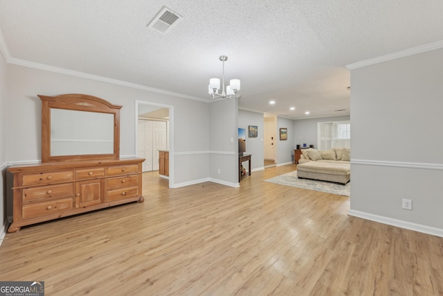 living room featuring a notable chandelier, ornamental molding, light hardwood / wood-style floors, and a textured ceiling