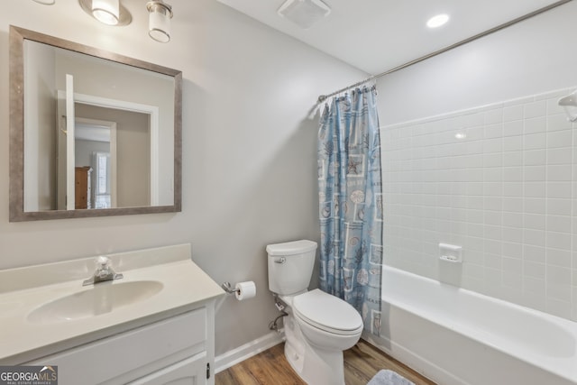 full bathroom with vanity, hardwood / wood-style floors, shower / tub combo with curtain, and toilet