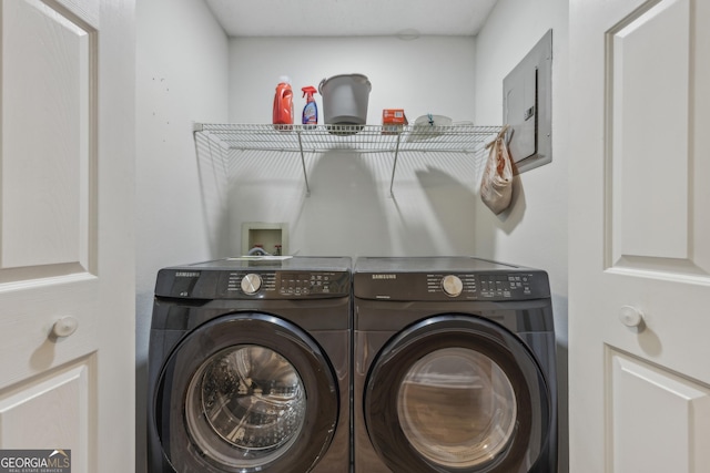 clothes washing area with washer and dryer