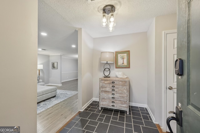 tiled foyer entrance featuring a textured ceiling