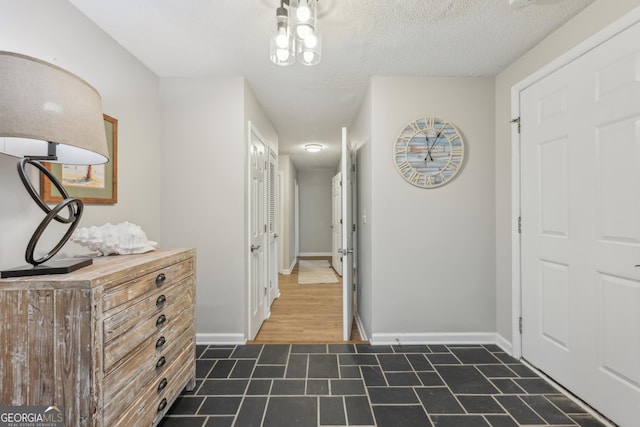 hallway with a textured ceiling