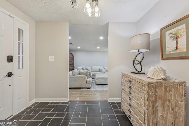 foyer entrance featuring a textured ceiling