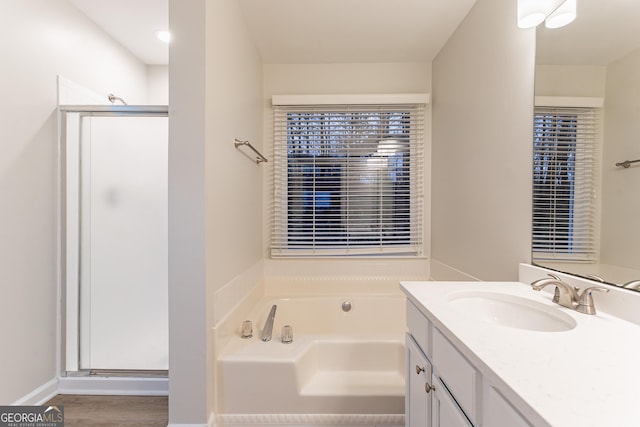 bathroom featuring vanity and plus walk in shower