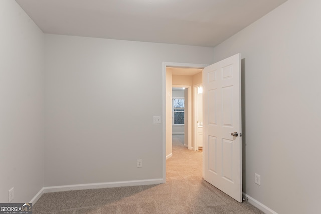 empty room featuring light carpet