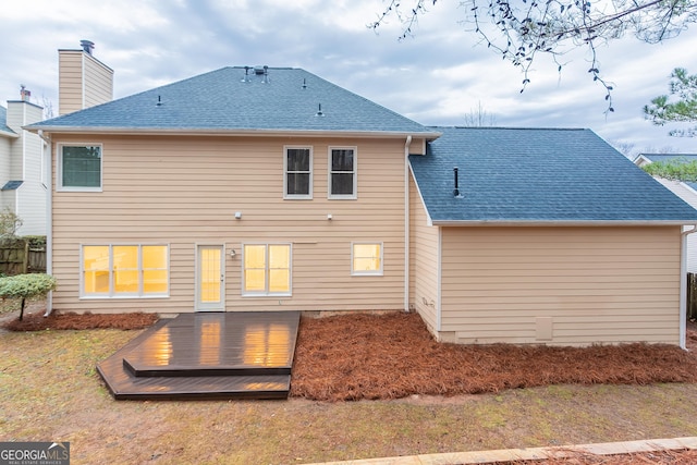 rear view of property featuring a deck