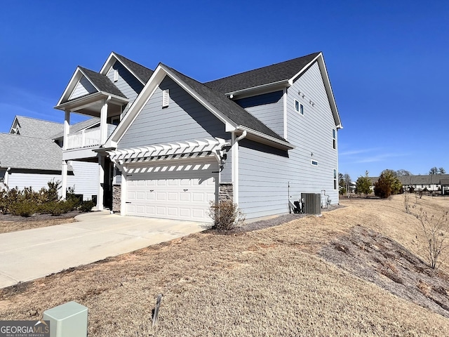 view of front of home featuring a balcony and central AC unit