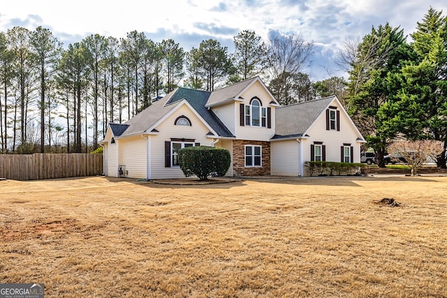 view of property featuring a front lawn