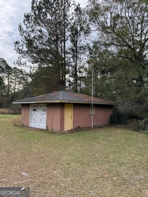 view of outbuilding featuring a yard