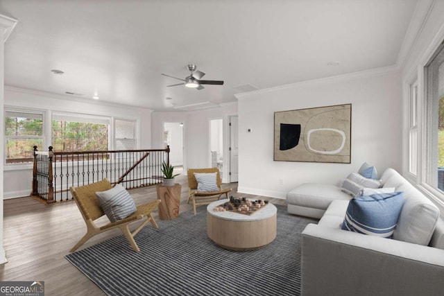 living room with hardwood / wood-style flooring and crown molding