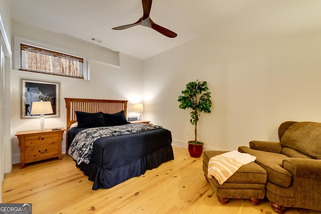 bedroom with ceiling fan and light hardwood / wood-style flooring