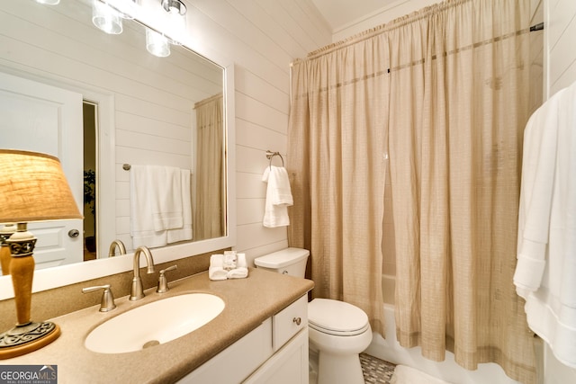 full bathroom with vanity, shower / bathtub combination with curtain, wooden walls, and toilet