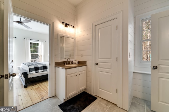 bathroom featuring vanity, tile patterned flooring, and ceiling fan