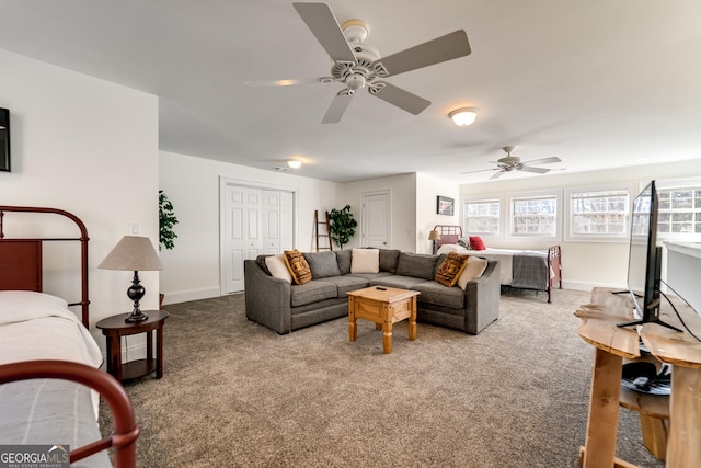 carpeted living room featuring ceiling fan