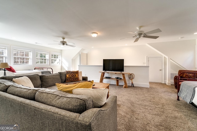 carpeted living room with ceiling fan