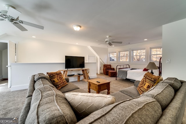 carpeted living room with ceiling fan