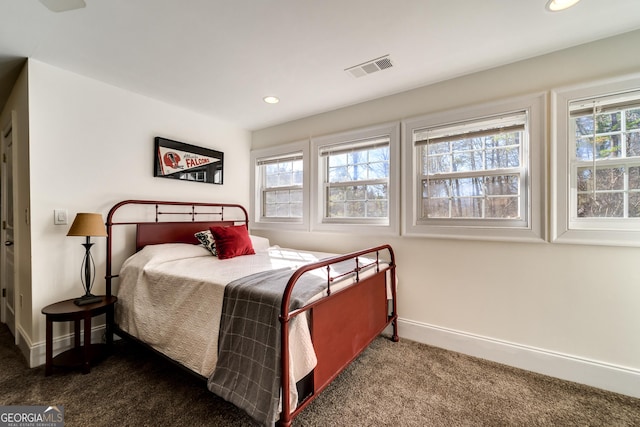 carpeted bedroom featuring multiple windows