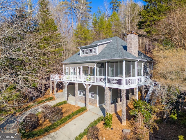 view of front facade featuring a sunroom and a patio