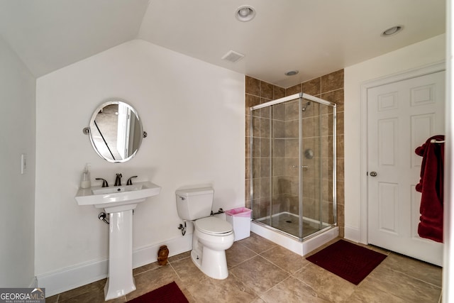 bathroom with an enclosed shower, vaulted ceiling, tile patterned floors, and toilet