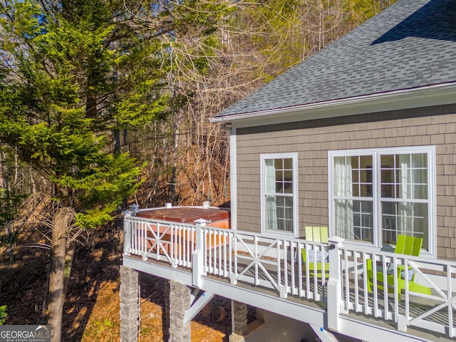 wooden deck with a hot tub