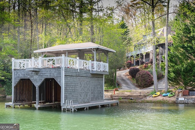 view of dock with a gazebo and a water view