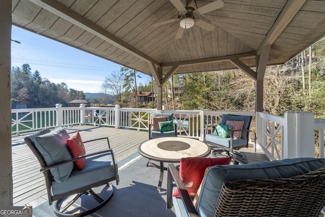 deck with a gazebo, ceiling fan, and an outdoor hangout area