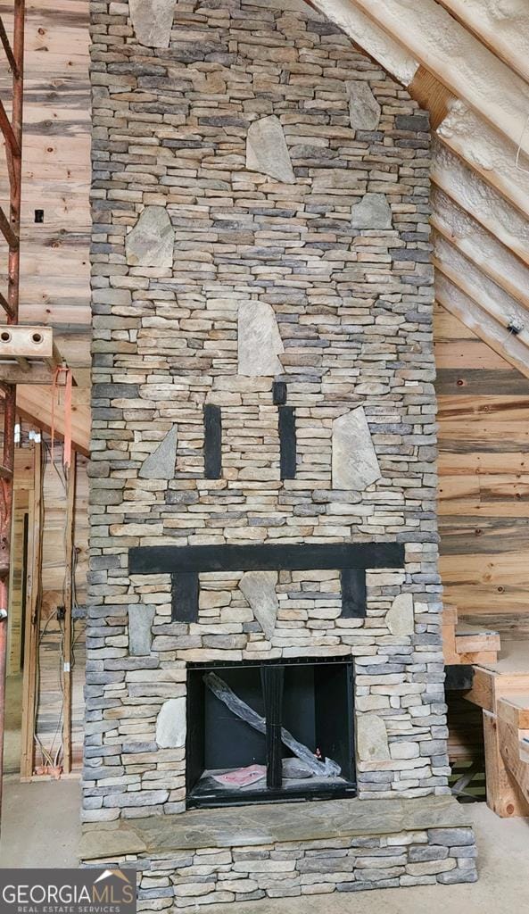 interior details featuring a stone fireplace