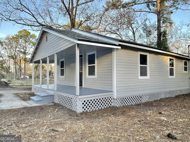 view of side of property with covered porch