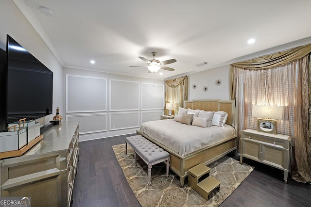 bedroom with dark hardwood / wood-style flooring, crown molding, and ceiling fan