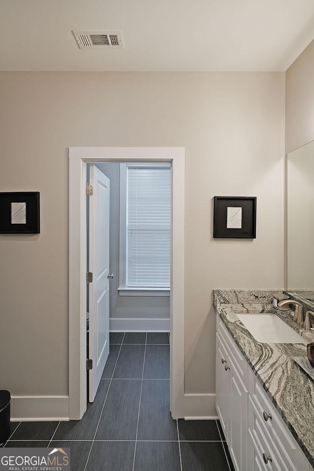 bathroom featuring tile patterned flooring and vanity