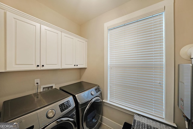 laundry room with cabinets and washing machine and dryer