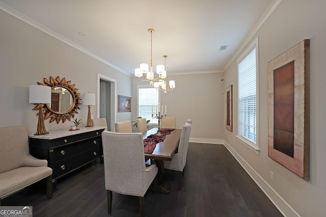 dining area with dark wood-type flooring, ornamental molding, and a chandelier