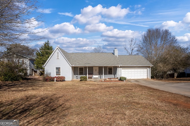 ranch-style house featuring a garage, covered porch, and a front lawn