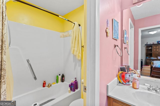 full bathroom with shower / tub combo with curtain, vanity, and toilet