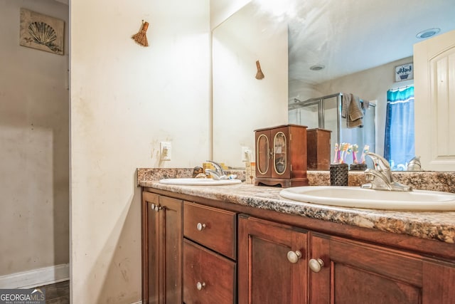 bathroom with vanity and a shower