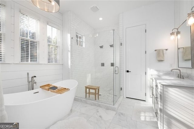 bathroom featuring vanity and separate shower and tub