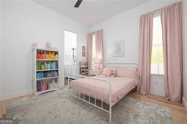 bedroom with hardwood / wood-style flooring and ceiling fan