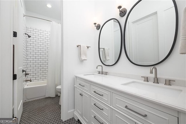 full bathroom featuring vanity, tile patterned floors, toilet, and shower / bath combo with shower curtain