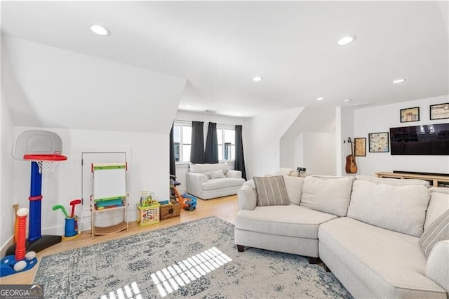 living room with hardwood / wood-style flooring and lofted ceiling