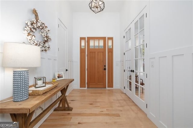 interior space with french doors and light hardwood / wood-style flooring