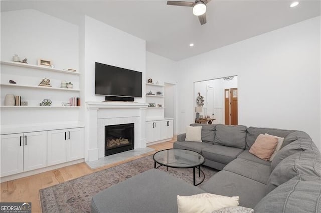 living room featuring light hardwood / wood-style flooring and ceiling fan