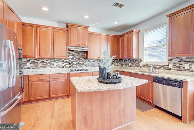 kitchen featuring under cabinet range hood, visible vents, appliances with stainless steel finishes, and light wood-style floors