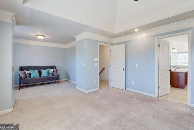 living area with carpet flooring, an upstairs landing, baseboards, and ornamental molding