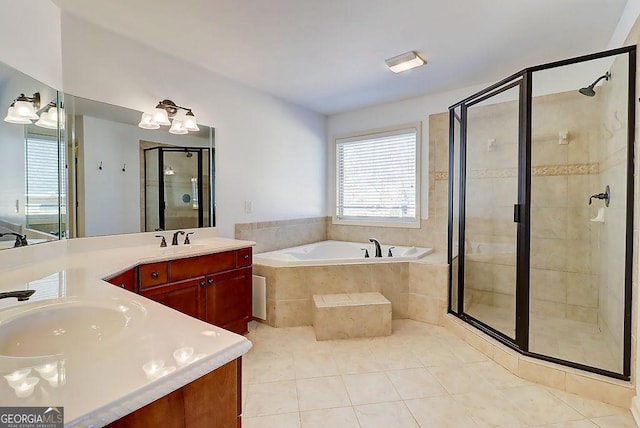 full bathroom featuring tile patterned flooring, a bath, vanity, and a stall shower