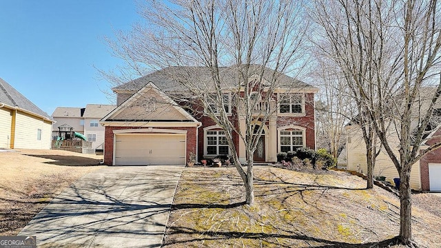 view of front facade with concrete driveway, an attached garage, and brick siding