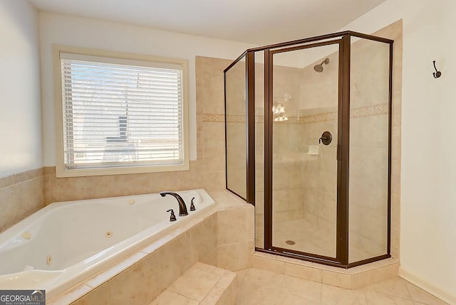 bathroom with tile patterned floors, a shower stall, and a whirlpool tub