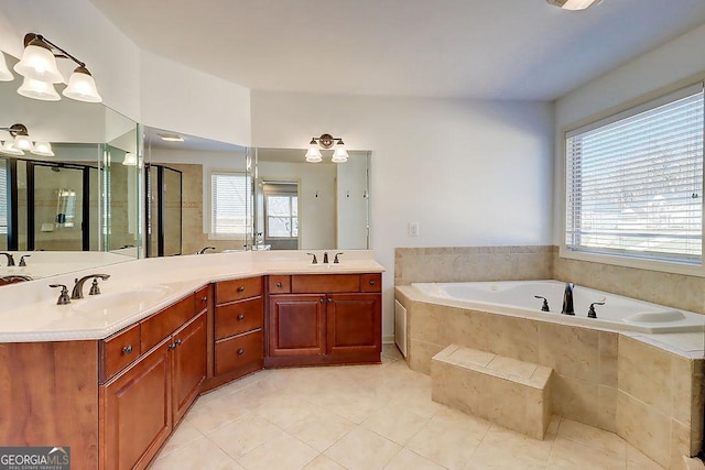 full bath featuring a stall shower, a bath, double vanity, and a sink