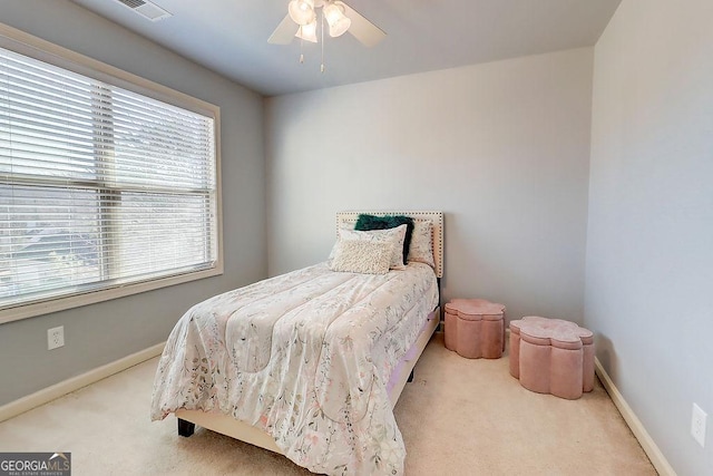 carpeted bedroom featuring visible vents, ceiling fan, and baseboards