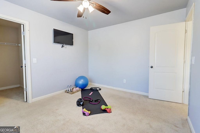 workout room with baseboards, carpet floors, and ceiling fan